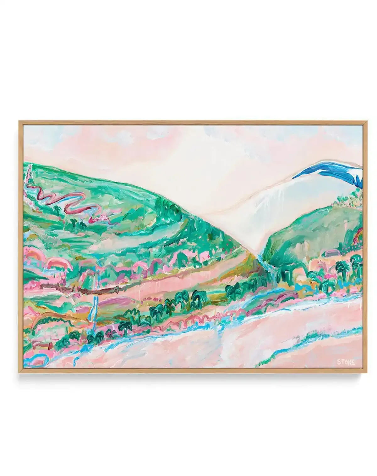 Abstract landscape canvas print titled "Springtime in the Yarra" by Belinda Stone, featuring rolling hills and a valley in vibrant shades of green, pink, and blue, with visible brushstroke texture, displayed in a natural oak frame. The composition includes a winding pink road on a green hillside, a light pink sky with hints of white clouds, and a body of water in the foreground with blue accents.
