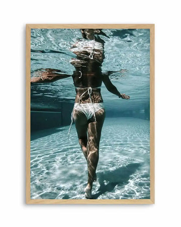 Swim art print — woman in white bikini in teal pool, rear view; natural oak frame, no mat