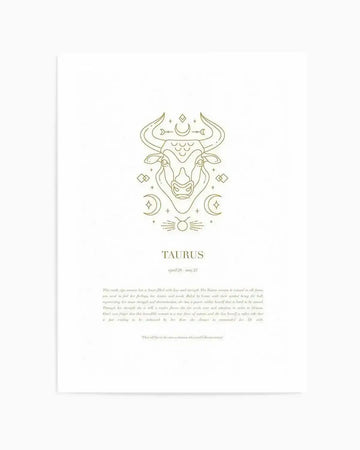 Art print featuring a minimalist line art illustration of a Taurus zodiac bull in metallic gold on a white background. The bull's head is centered, adorned with celestial elements like crescent moons, stars, and geometric shapes. Below the illustration, the word "TAURUS" is printed in gold, followed by "april 20 - may 21" in a smaller font. The bottom of the print includes a paragraph of text in a light grey font describing the Taurus personality traits.