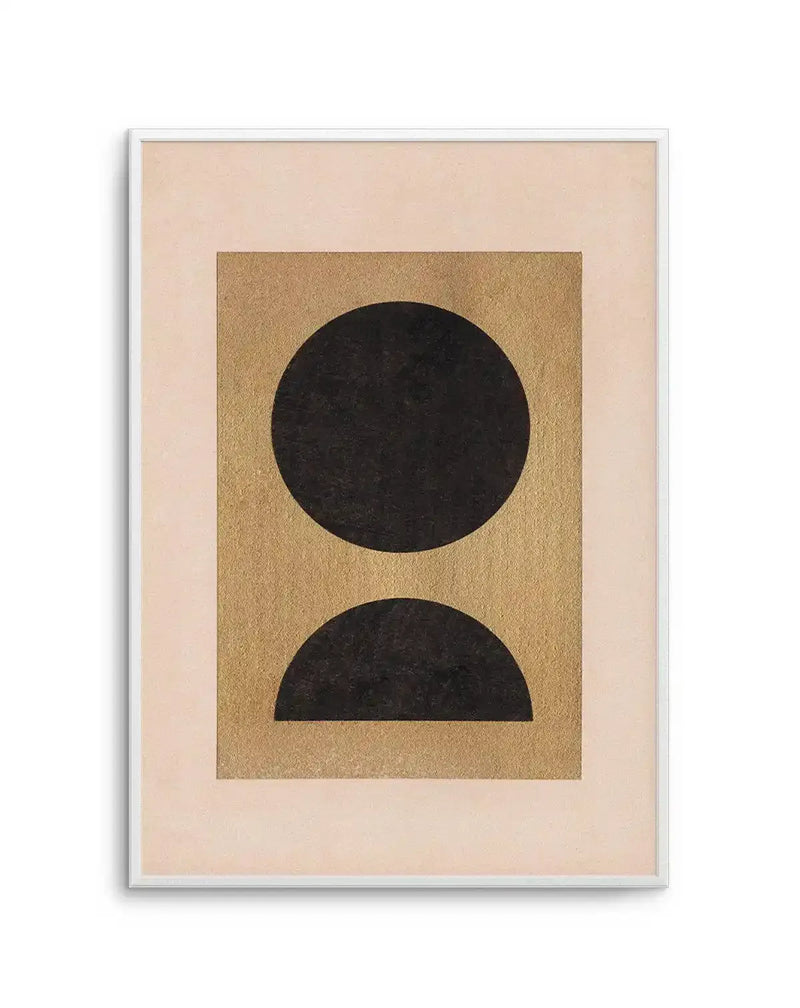 Abstract art print featuring a large black circle positioned above a black semicircle, both with a textured, slightly distressed appearance, set against a warm golden-brown rectangular background with a subtle shimmer. The print is displayed in a white frame with a white border, and the golden-brown rectangle is centered on a light cream-colored paper.