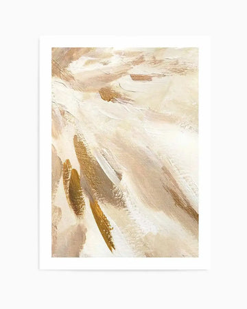 Abstract art print featuring sweeping brushstrokes in cream, ivory, and gold tones with darker golden-brown accents. The composition shows diagonal and curved gestural marks creating a sense of movement across the canvas. The painting has an oil or acrylic finish with visible texture and layered, translucent application. The artwork is displayed in a white frame with white border against a plain background.