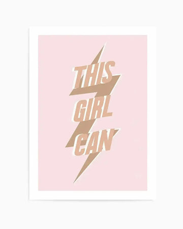 Art print featuring the phrase "THIS GIRL CAN" in a bold, uppercase font, with each word stacked vertically. The text is rendered in a light tan or beige color and is overlaid on a stylized lightning bolt graphic in a slightly darker brown or taupe shade. The background of the print is a soft, pale pink. The overall composition is dynamic and empowering.