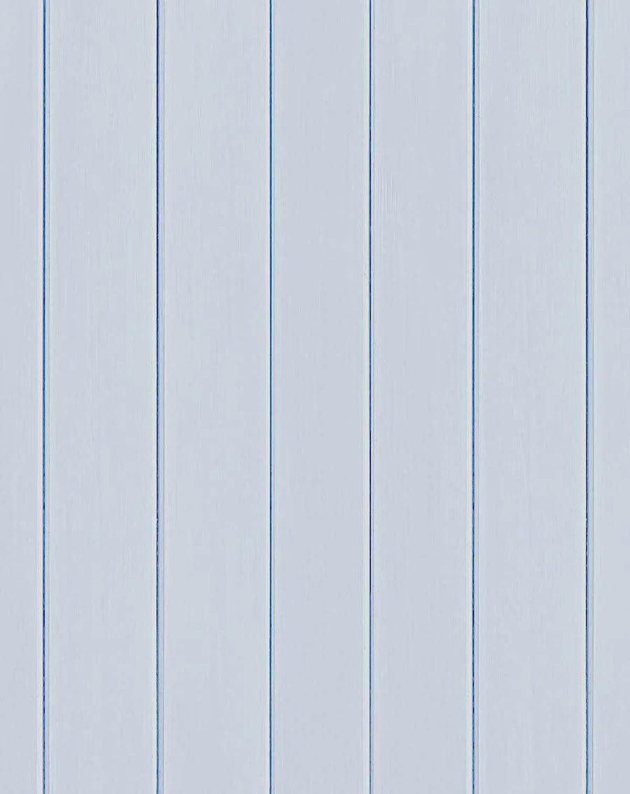 Tongue and groove wood panel wallpaper featuring evenly spaced vertical planks in ice blue and pale gray tones. The panels have a subtle wood grain texture and are separated by darker blue grooves running the full height of the image, creating a clean, linear pattern typical of beadboard or shiplap styling.