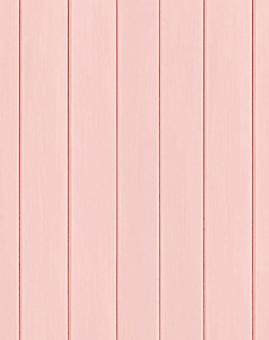 Tongue and groove wood panel wallpaper in dusty rose pink. Five vertical wooden planks with subtle wood grain texture and lighter cream-colored grooves between each panel, creating a clean, linear pattern across the entire surface. The finish has a soft, matte appearance suggesting painted or sealed wood.