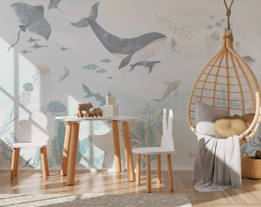 Child's playroom with ocean blue-grey mural, white table, wooden chairs and hanging rattan egg chair