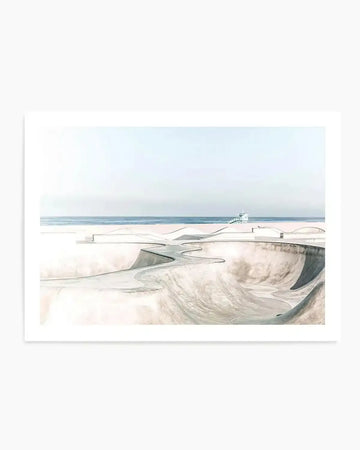 Art print featuring a minimalist, almost ethereal, photographic depiction of the Venice Skate Park with the ocean and a lifeguard tower in the background under a pale blue sky. The skate park's concrete bowls and winding paths are rendered in soft grey and white tones, creating a serene, almost dreamlike landscape.
