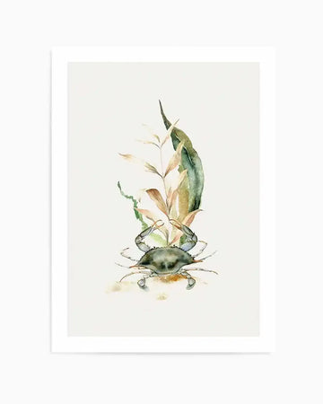 Watercolour art print featuring a blue crab on sandy ground with various aquatic plants. The crab has a dark blue-grey shell with lighter blue claws and legs, and is positioned slightly to the left of center. Behind the crab, tall, slender leaves in shades of muted green and warm beige rise upwards, creating a natural, serene composition.
