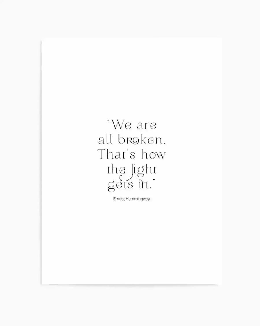 Art print featuring a quote in elegant, thin serif typography on a clean white background. The quote reads: "We are all broken. That's how the light gets in." with "Ernest Hemmingway" in smaller text below.