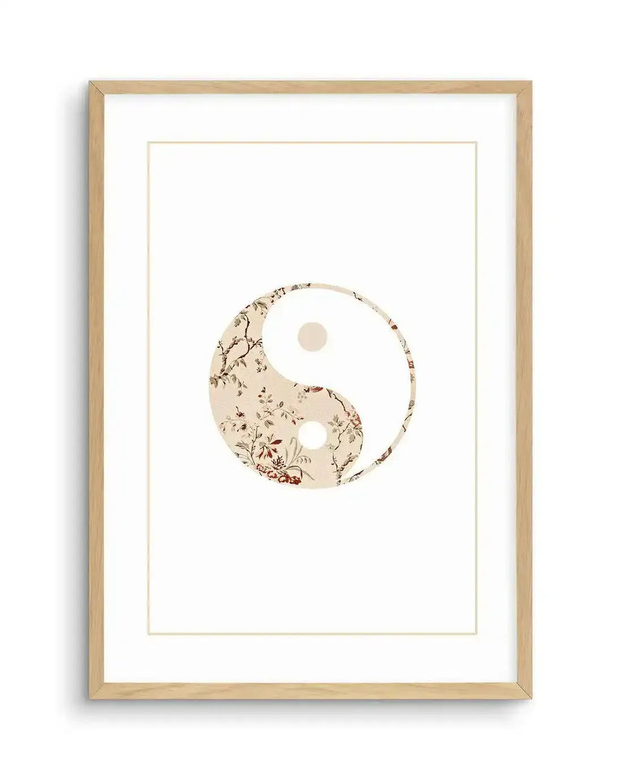 Art print featuring a Yin & Yang symbol with one half in solid white and the other half adorned with a delicate floral pattern in muted red, brown, and cream tones, printed on fine art paper and displayed in a natural oak frame with white border.