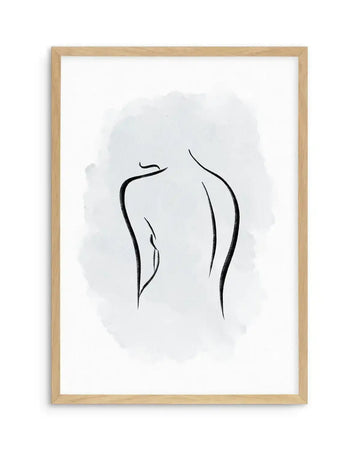 Framed art print featuring a minimalist line drawing of an abstract female back view in black ink on white paper with a soft grey-blue watercolor wash background. The figure shows elegant curved lines depicting the spine and shoulders. Natural wood frame with light finish surrounds the artwork.