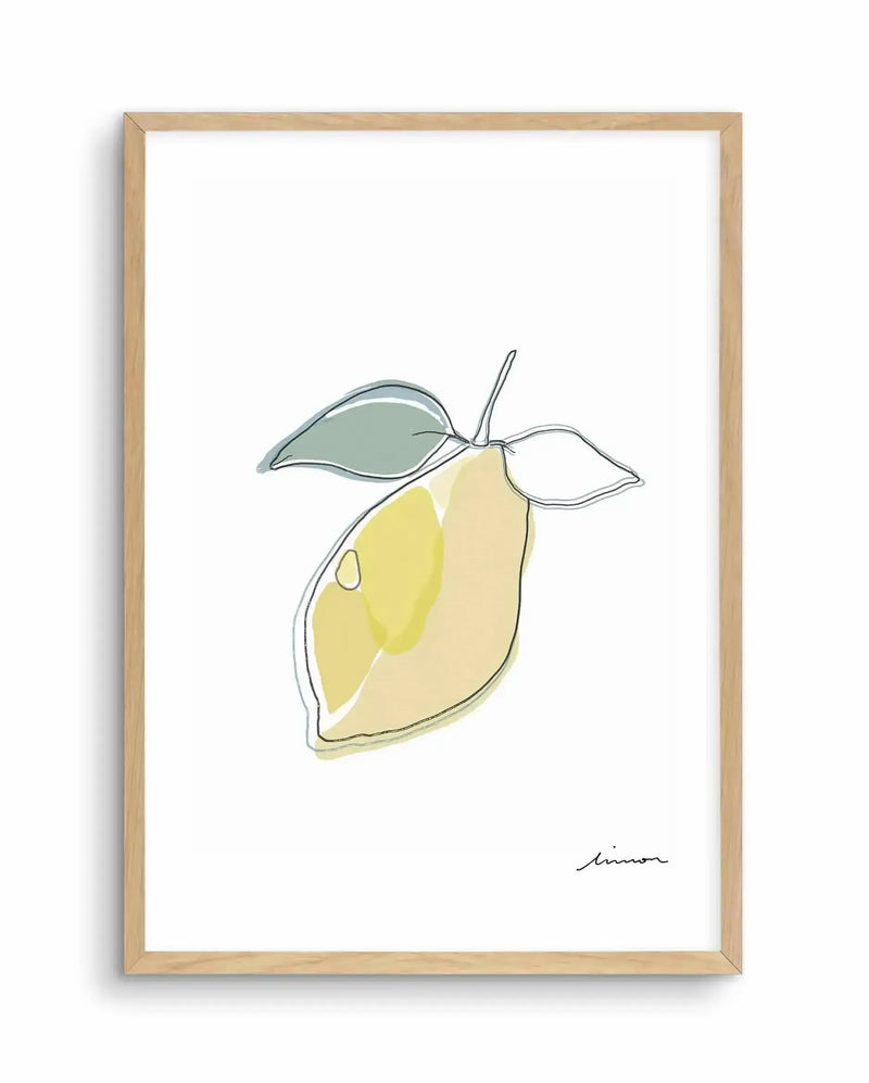 Abstract art print featuring a minimalist line drawing of a lemon with two leaves, in black outline with washes of pale yellow and sage green, displayed in a natural oak frame with white border. The word "limon" is written in script in the bottom right corner.