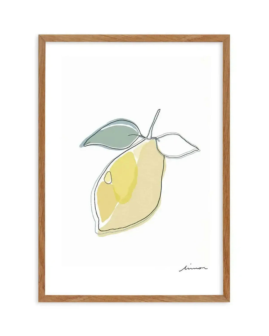 Abstract art print featuring a single lemon with two leaves, outlined in a thin black line with washes of pale yellow and chartreuse green, printed on fine art paper and displayed in a natural oak frame with white border.