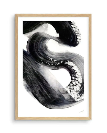 Abstract art print featuring bold, sweeping brushstrokes in black and dark grey, creating a dynamic, fluid, and somewhat calligraphic composition on a white background. The strokes vary in opacity and texture, with some areas showing visible brush hairs and lighter grey washes, displayed in a natural oak frame with white border.