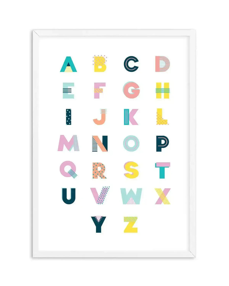 Alphabet art print featuring all 26 uppercase letters of the English alphabet, each with a unique geometric pattern and colour scheme in bright, playful tones of teal, pink, yellow, and blue. The letters are arranged in a grid on a white background and displayed in a white frame with a white border.
