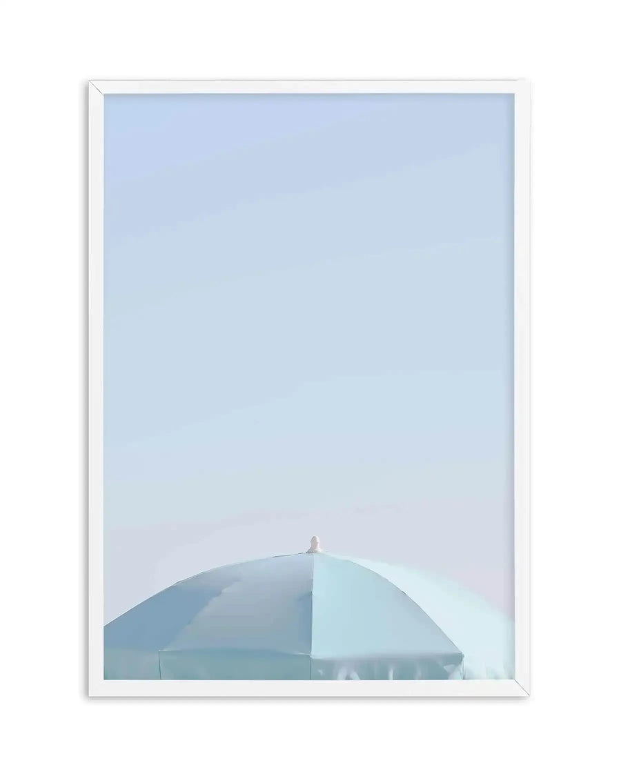 Framed photography art print of the top of a light aqua blue parasol against a clear, pale blue sky, with a white frame and white border. The parasol is seen from a low angle, filling the bottom third of the frame, with its small, light-colored finial at the very top.
