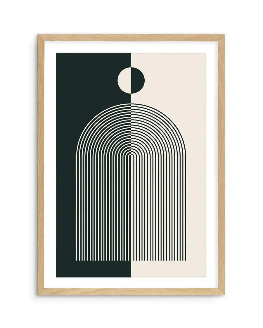 Abstract art print featuring a symmetrical composition divided vertically down the middle. The left side has a dark teal background with white concentric arcs forming a half-dome shape, topped by a white half-circle. The right side has a cream background with black concentric arcs forming the other half of the dome, topped by a black half-circle. The print is displayed in a natural oak frame with a white border.