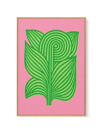 Framed canvas art print featuring a stylized illustration of a plant with large leaves in bright lime green against a vibrant bubblegum pink background, displayed in a natural oak frame. The leaves are composed of parallel curved lines, with a central spiral design at the top.