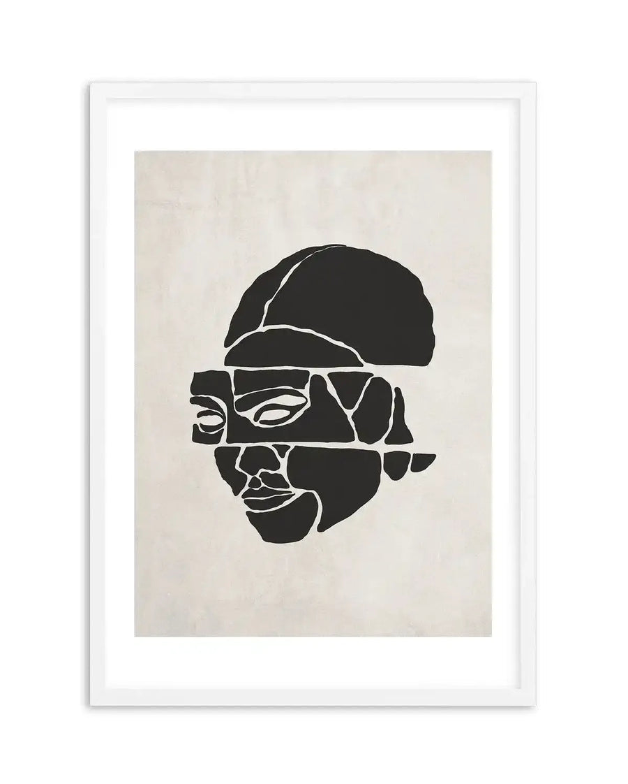 Abstract art print featuring a fragmented black silhouette of a face against a textured off-white background, displayed in a white frame with a white border. The face is depicted in profile, with the top of the head and the facial features (eyes, nose, mouth) separated into horizontal bands and broken into irregular geometric shapes, creating a deconstructed, cubist-like composition.