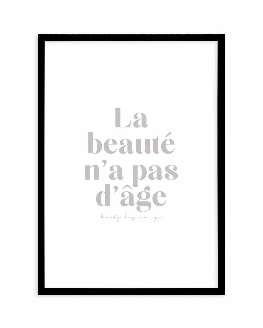 Art print featuring the French phrase "La beauté n'a pas d'âge" (Beauty has no age) in large, light grey, serif font, with the English translation "beauty has no age" in a smaller, handwritten-style font below. The print is displayed in a black frame with a white border.