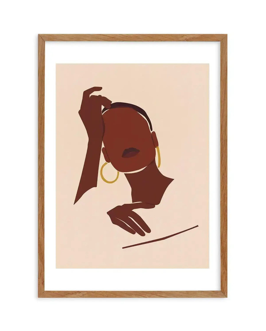 Abstract art print featuring a minimalist illustration of a woman's head and shoulders in rich brown tones against a light beige background, displayed in a natural oak frame with white border. The woman has dark brown skin, a short dark hairstyle, and wears large gold hoop earrings. Her right hand is raised to her head, and her left hand rests near her chest.