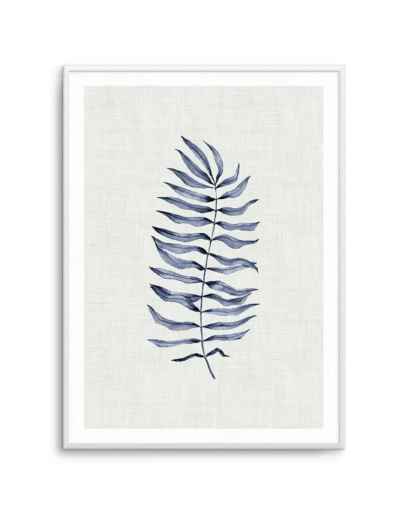 Watercolour art print featuring a single fern frond with multiple small leaves extending from a central stem, painted in varying shades of indigo and slate blue on a textured cream background, displayed in a white frame with white border.