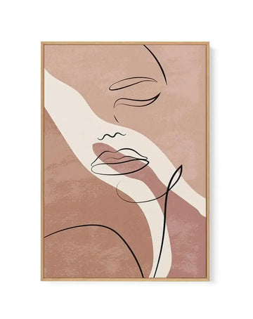 Abstract line art canvas print featuring a minimalist female face in profile with closed eyes and full lips, rendered in a single continuous black line. The background is a textured blend of blush pink and muted terracotta, with a wide, curving cream stripe running diagonally across the composition. The canvas is displayed in a natural oak frame.