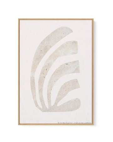 Framed canvas art print featuring an abstract botanical design of five curved, fan-like shapes arranged vertically in cream and pale beige tones with subtle speckled texture throughout. The composition is centered on a light off-white background. The artwork is displayed in a natural wood frame with a white border. Text at the bottom reads "le vie dans la pierre" and "A life in stone exhibition". The overall aesthetic is minimal and contemporary with an organic, natural quality.