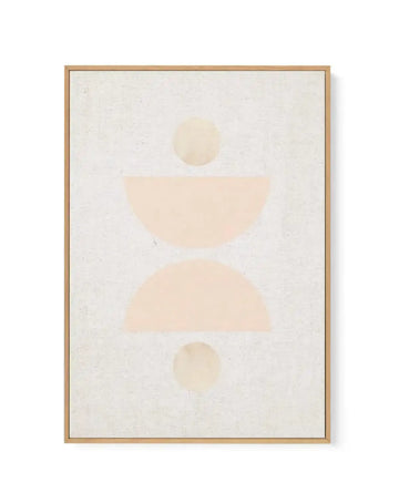 Framed canvas art print featuring an abstract minimalist composition on a cream textured background. The design consists of soft geometric shapes in warm beige and pale peachy tones arranged vertically: a small circle at top, a curved semicircle in the middle, a larger organic shape below, and another small circle at the bottom. The artwork has a matte finish with subtle watercolor-like quality. Natural wood frame with light tan finish and white border surrounding the canvas.