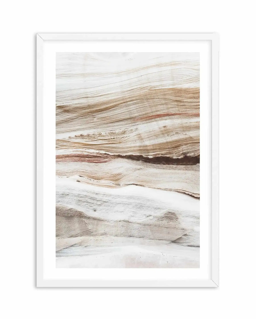 Framed art print titled Bronte Rocks I displayed in a white frame with white border. The artwork features a detailed photograph of layered rock formations with horizontal striations in varying shades of cream, tan, brown, and rust. The natural stone layers create organic, flowing patterns with subtle textures and depth. The composition is vertical, capturing the geological character of the rock face with realistic detail and earthy, neutral tones throughout.