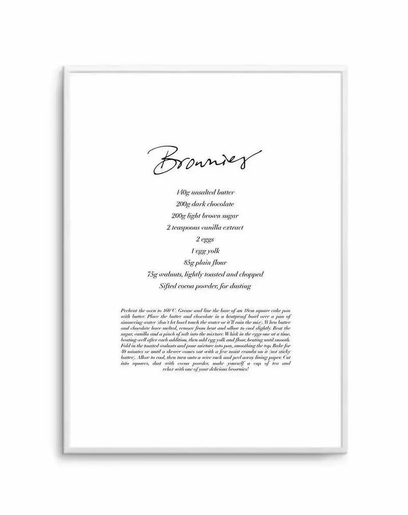 Framed art print featuring a brownie recipe on white background. Title "Brownies" in cursive script at top, followed by ingredient list in italics including butter, dark chocolate, brown sugar, vanilla, eggs, flour, walnuts, and cocoa powder. Below ingredients is detailed recipe instructions in smaller italic text. Light gray wooden frame with white border surrounding the entire composition.