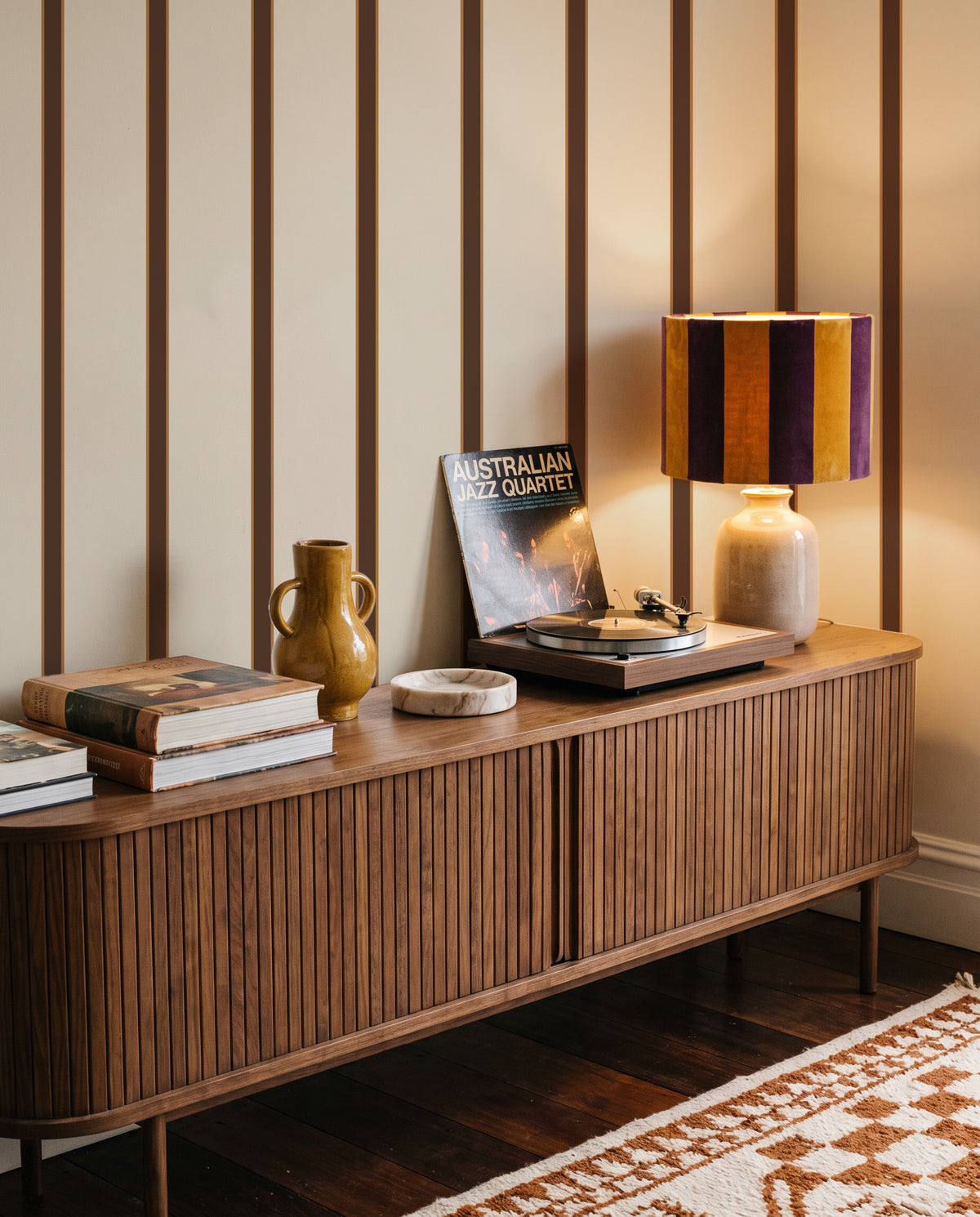 Brown and Caramel Cabana Stripe wallpaper behind a timber sideboard