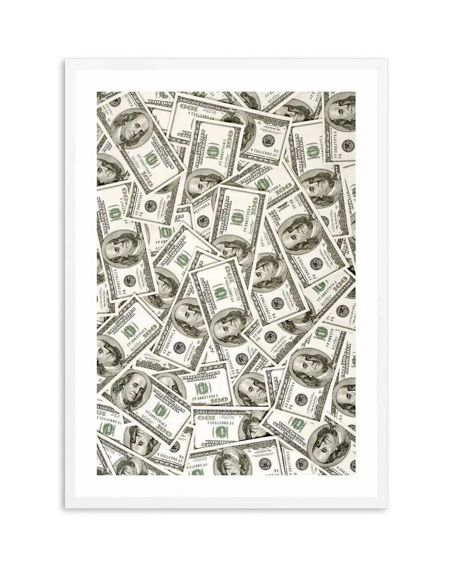 Art print featuring a dense, chaotic pile of US one hundred dollar bills, with Benjamin Franklin's portrait visible on many of the bills, printed on fine art paper and displayed in a white frame with white border.