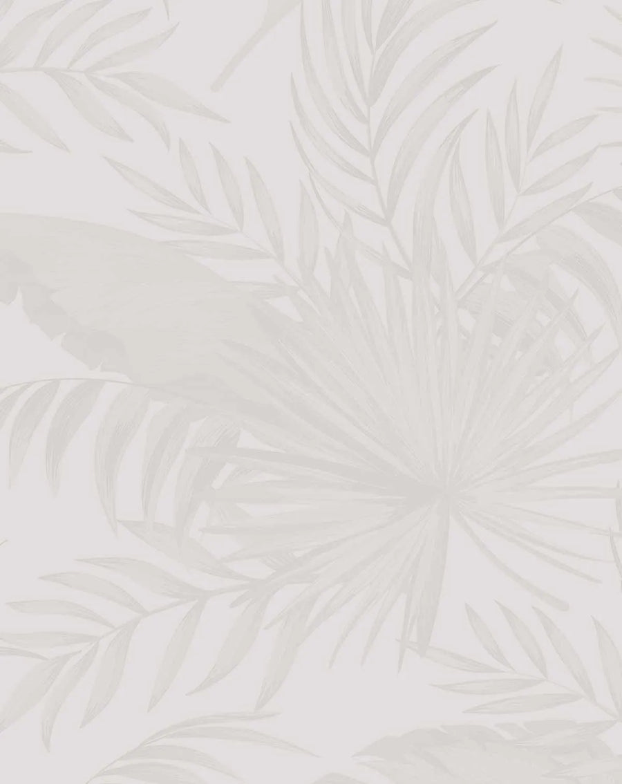 Coastal Luxe Palms Wallpaper in Warm Grey featuring a botanical design of layered palm fronds in soft taupe, beige, and grey tones. The fronds are rendered with delicate brushstroke details and varying opacity, creating depth and movement across a light cream background. The design has a watercolor-inspired quality with subtle texture and a naturalistic, flowing composition that repeats across the wallpaper surface.