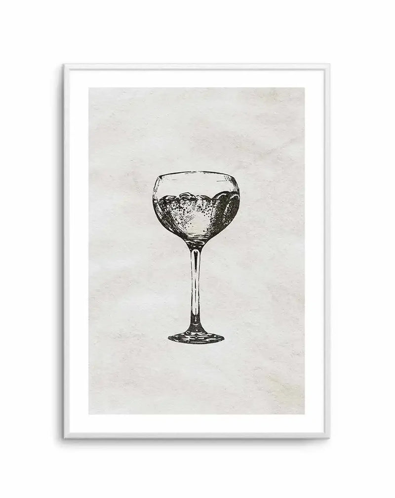 Black ink sketch of a cocktail glass filled with bubbling liquid on a cream textured background, framed in white with white border. The drawing shows fine line work detail in the glass stem and bowl with cross-hatching for shadow and dimension, rendered in a vintage engraving style.