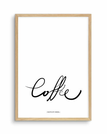 Framed art print featuring the word "Coffee" written in an elegant, flowing black script handwriting style against a white background. The design is centered in the lower portion of the print, with a small text credit line at the bottom. The artwork is displayed in a natural light wood frame with a white border.