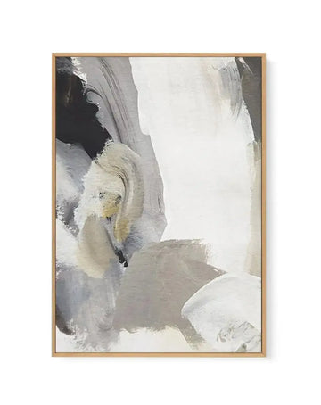 Abstract canvas print featuring bold, expressive brushstrokes in shades of black, white, and various greys, with subtle hints of warm beige and pale yellow. The composition has a dynamic, fluid quality with layered textures, framed in natural wood.