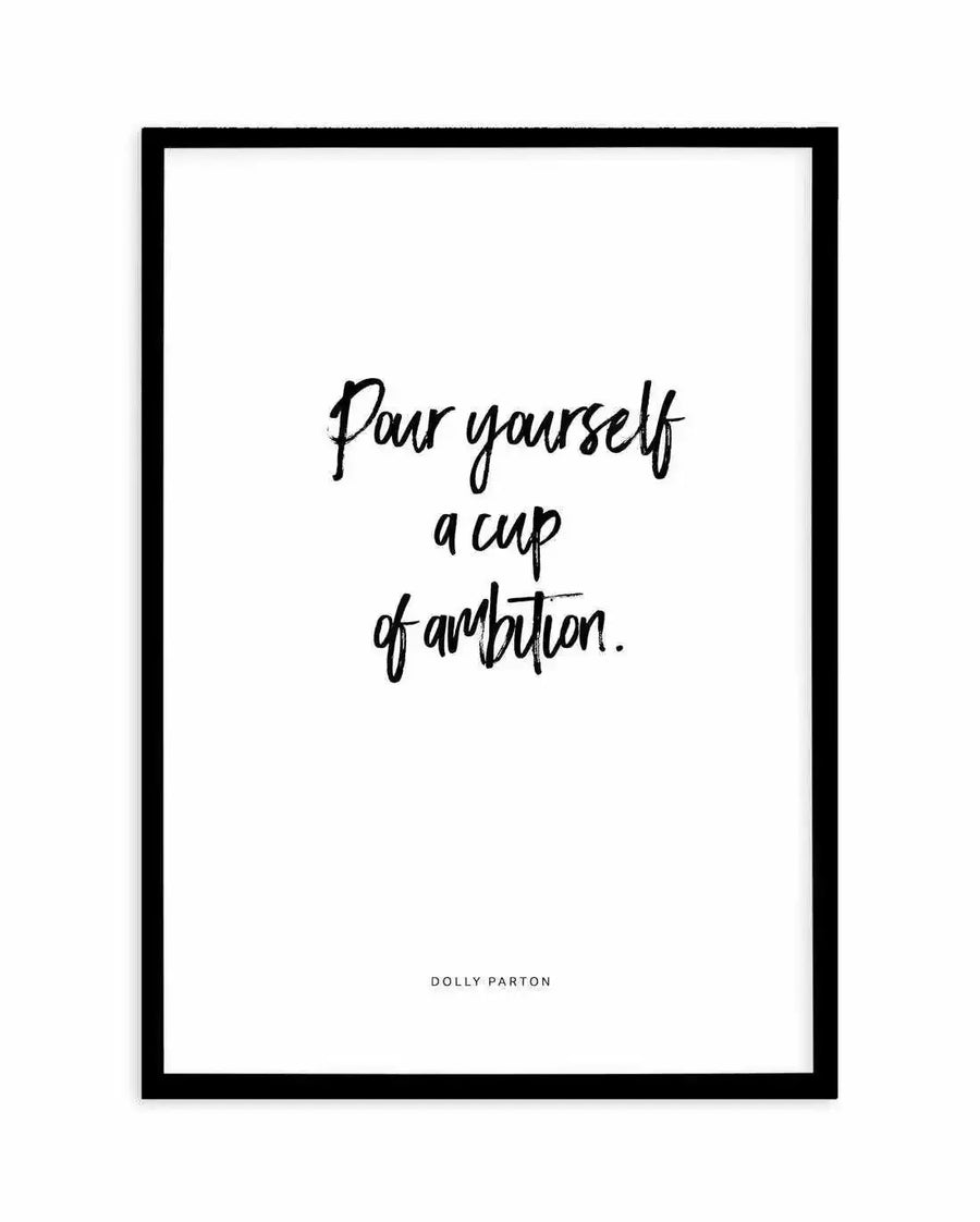 "Motivational art print featuring the quote 'Pour yourself a cup of ambition.' in a handwritten brush script font in black, on a clean white background, printed on fine art paper and displayed in a sleek black frame with white border."