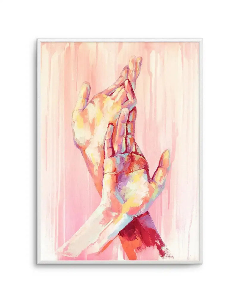 Oil paint art print featuring two hands, one reaching up and one crossing over, rendered in vibrant brushstrokes of pink, yellow, blue, and red, against a soft pink background with vertical paint drips, displayed in a white frame with white border.
