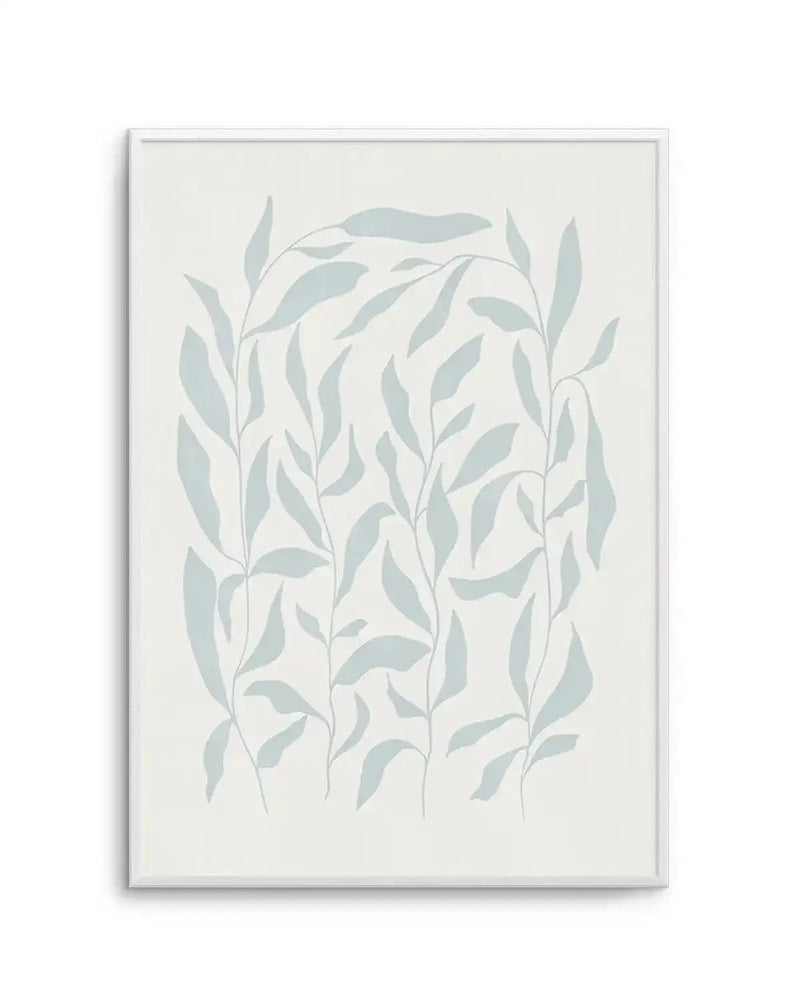 Art print featuring an illustration of several tall, slender leafy branches in a soft, muted sage green against a warm off-white background, displayed in a white frame with a white border. The leaves are depicted with a simple, flat graphic style, creating a calm and minimalist botanical composition.