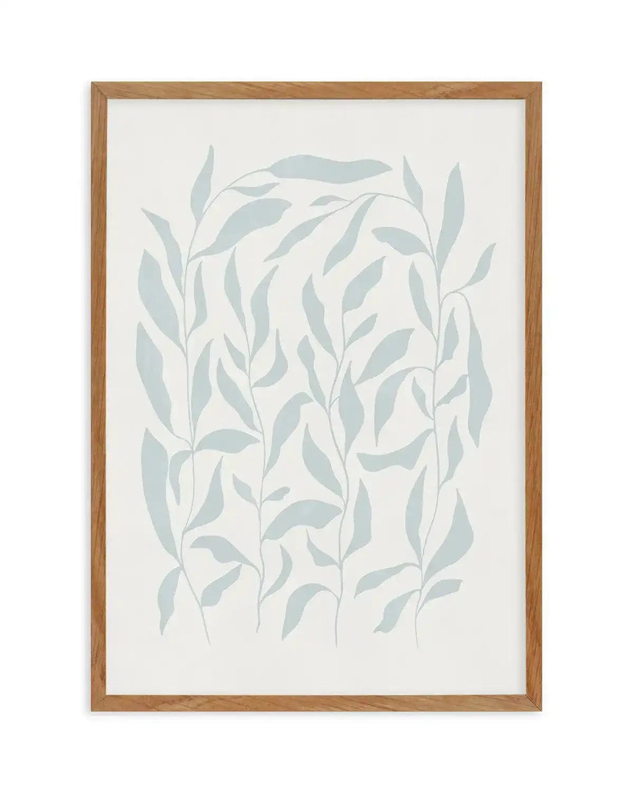 Art print featuring a minimalist illustration of various leafy plant stems in a soft, muted blue-green hue on a clean white background, displayed in a natural oak frame with white border.