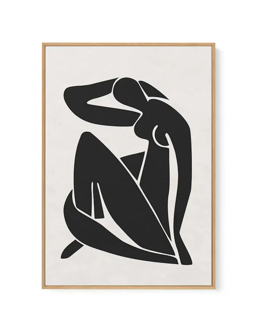 Framed canvas art print featuring an abstract black silhouette of a seated female figure against a cream background. The minimalist illustration uses bold black shapes with thin white outlines and negative space to define the form, creating a modern, geometric composition. The figure is depicted in a contemplative pose with one arm raised. The artwork is presented in a natural wood frame with a clean, simple border.