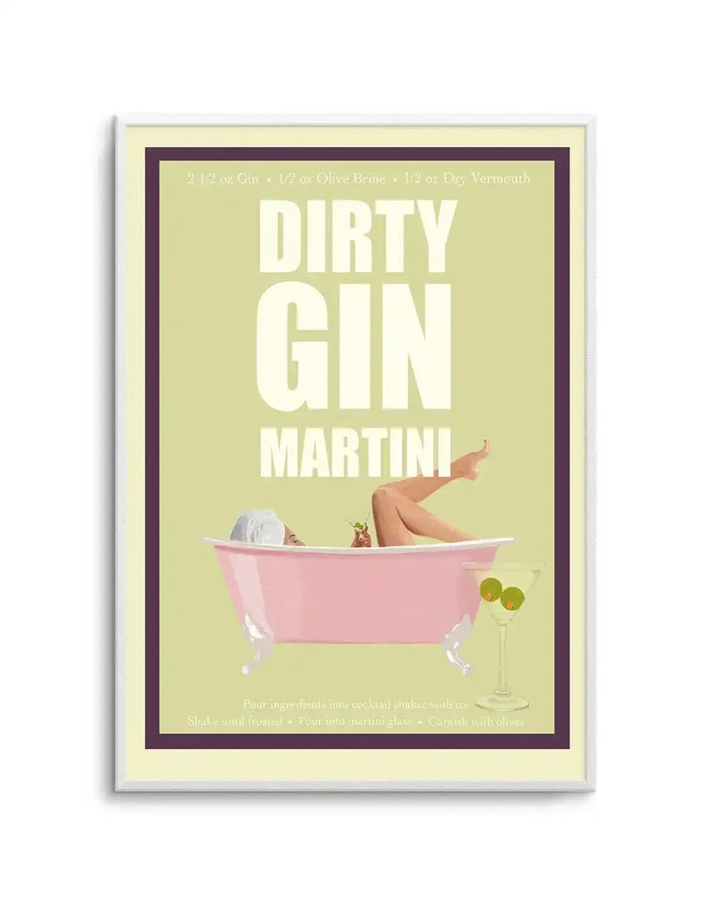 Art print featuring a retro-style illustration of a woman relaxing in a pink bathtub, with her legs propped up and a cocktail in hand, against a pale lime green background. The text "DIRTY GIN MARTINI" is prominently displayed in white, with a recipe at the top and instructions at the bottom. A martini glass with olives sits beside the tub. The print is displayed in a white frame with a thin dark purple border and a cream inner border.
