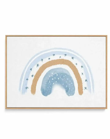 Framed canvas art print featuring a dreamy watercolor illustration of concentric rainbows in soft blue, tan, and white, decorated with delicate gray stars scattered around the outer arc and white dots filling the center curve. Natural wood frame with white border on linen background, creating a gentle, whimsical aesthetic.