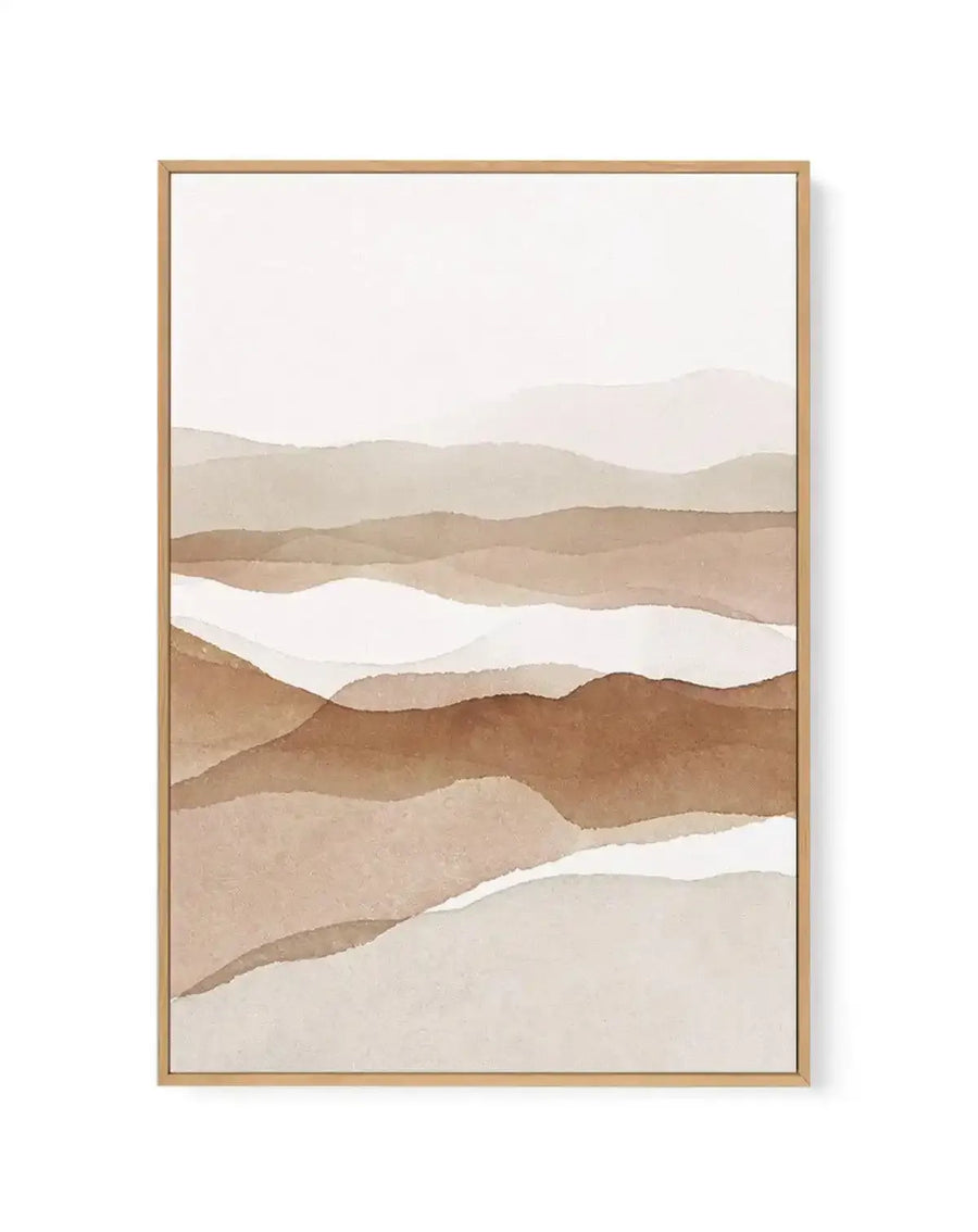 Earthen II framed canvas art print featuring abstract layered landscape in warm earth tones. Watercolour-style illustration depicts undulating hills and valleys in shades of tan, beige, brown, and cream, with white negative space creating flowing bands throughout composition. Natural wood frame with white border surrounding the artwork. Soft, minimalist aesthetic with gentle colour gradations evoking desert or rolling terrain.