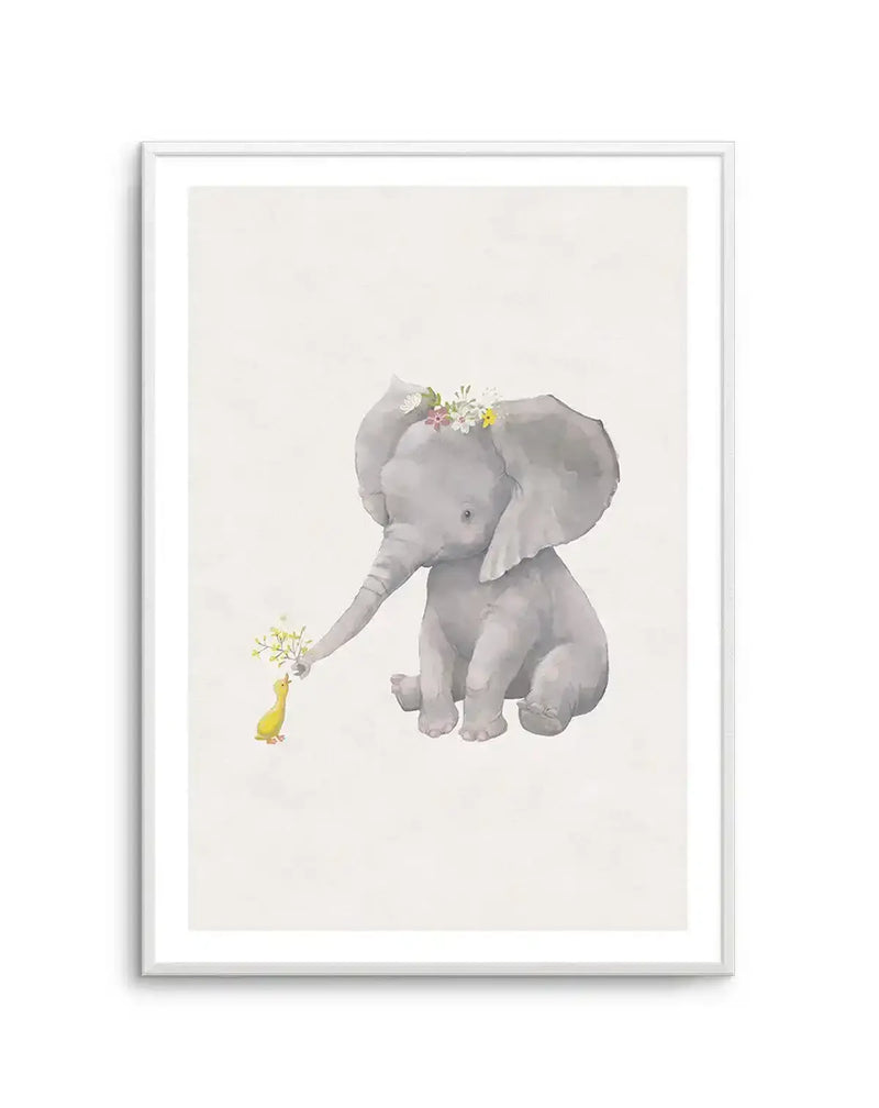 Watercolour art print featuring a baby elephant with a flower crown on its head, sitting and extending its trunk to offer a small bunch of yellow flowers to a tiny yellow duckling. The artwork has a soft, whimsical quality with muted grey tones for the elephant and bright yellow accents for the duckling and flowers, displayed in a white frame with a white border.