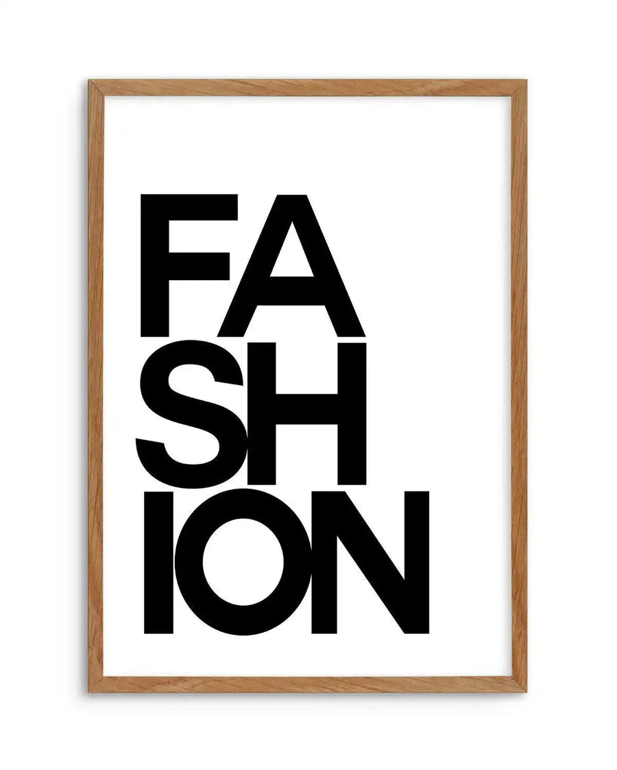 Art print featuring the word "FASHION" in bold black sans-serif capital letters, stacked vertically with "FA" on the first line, "SH" on the second, and "ION" on the third, against a clean white background, displayed in a natural oak frame with white border.