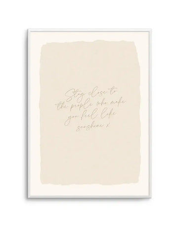 Art print featuring the quote "Stay close to the people who make you feel like sunshine x" in elegant script lettering on a textured cream background, displayed in a white frame with white border.