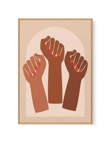 Framed canvas art print featuring three raised fists in varying shades of brown and terracotta against a soft beige background. The fists are illustrated in a flat, minimalist style with red accent lines on the knuckles. The composition is centered within a pale pink oval backdrop. The artwork is mounted in a natural wood frame with a cream-colored border. The overall palette consists of warm, earthy tones creating a calm, unified aesthetic.