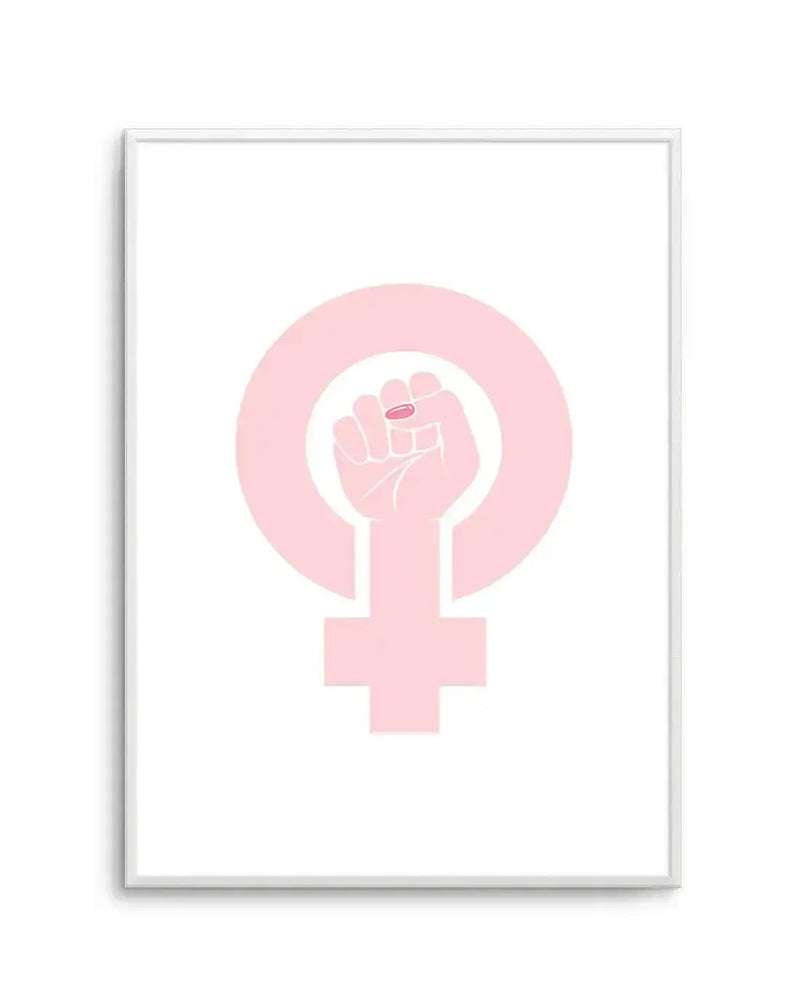 Art print featuring a pale pink female symbol with a raised fist inside the circle, holding a small pink pill, displayed in a white frame with a white border.