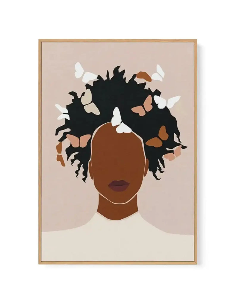 Framed canvas art print depicting an illustration of a woman with deep brown skin and dark, voluminous curled hair adorned with white and rust-colored butterflies. She has a burgundy lip and neutral expression, wearing a cream-colored garment. The background is soft taupe, and the artwork is rendered in a flat, minimalist illustration style with clean lines. The canvas is set in a natural wood frame with a thin white border.